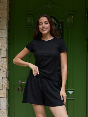 Black lace short-sleeve top worn as an everyday piece