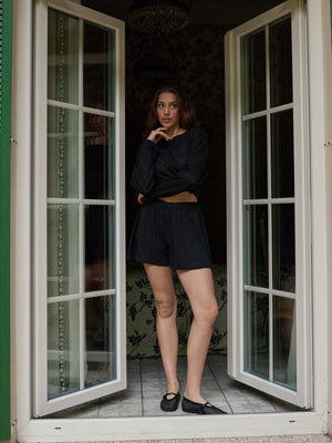 Black lace shorts styled as summer resort wear