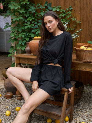 Black lace shorts worn as part of a coordinated look