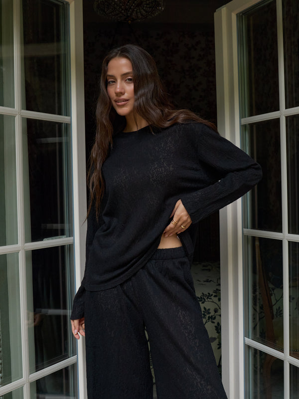 Sleeve detail of the MUSSONY black lace top