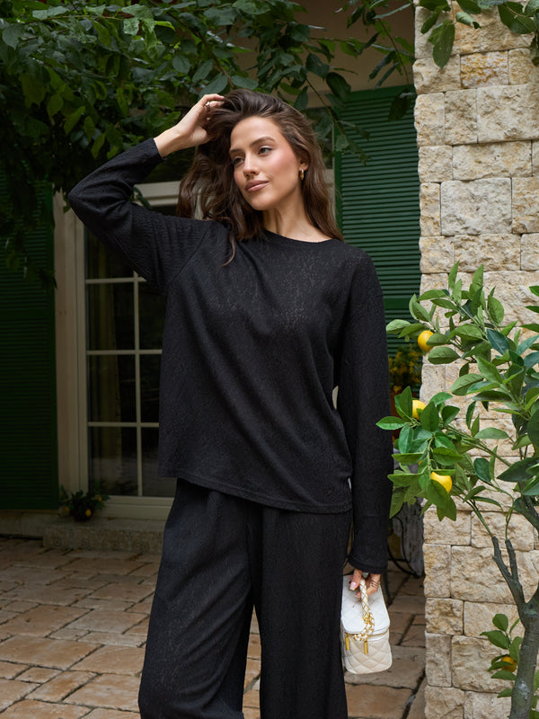 Black lace top shown as part of a coordinated look