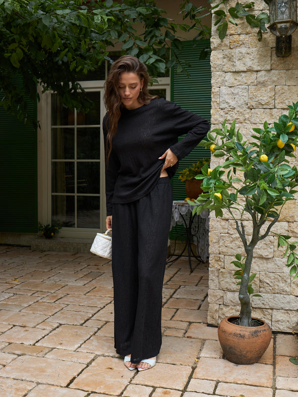 Black lace long-sleeve top worn with the matching set
