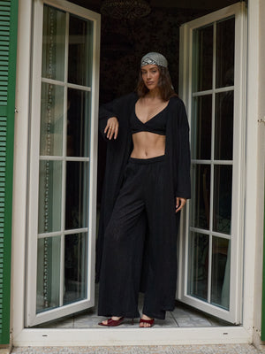 Front view of the black lace kimono showing its relaxed, floor-skimming silhouette