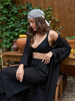 Black lace kimono sleeve detail, worn seated