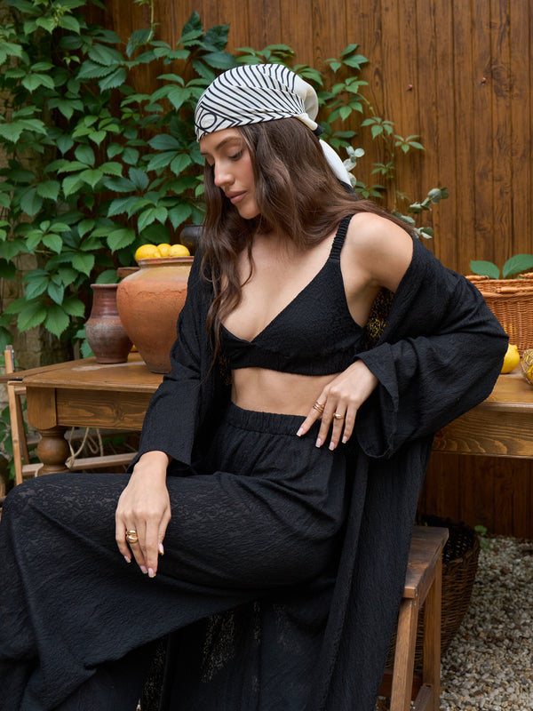 Black lace kimono sleeve detail, worn seated