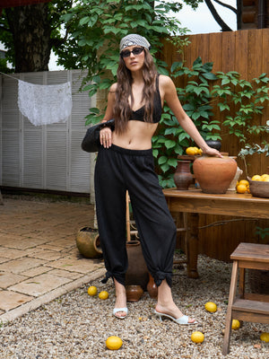 Black lace pants worn as part of a coordinated summer look