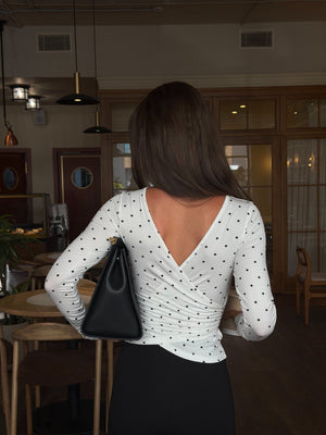 MUSSONY polka dot wrap top with a fitted silhouette